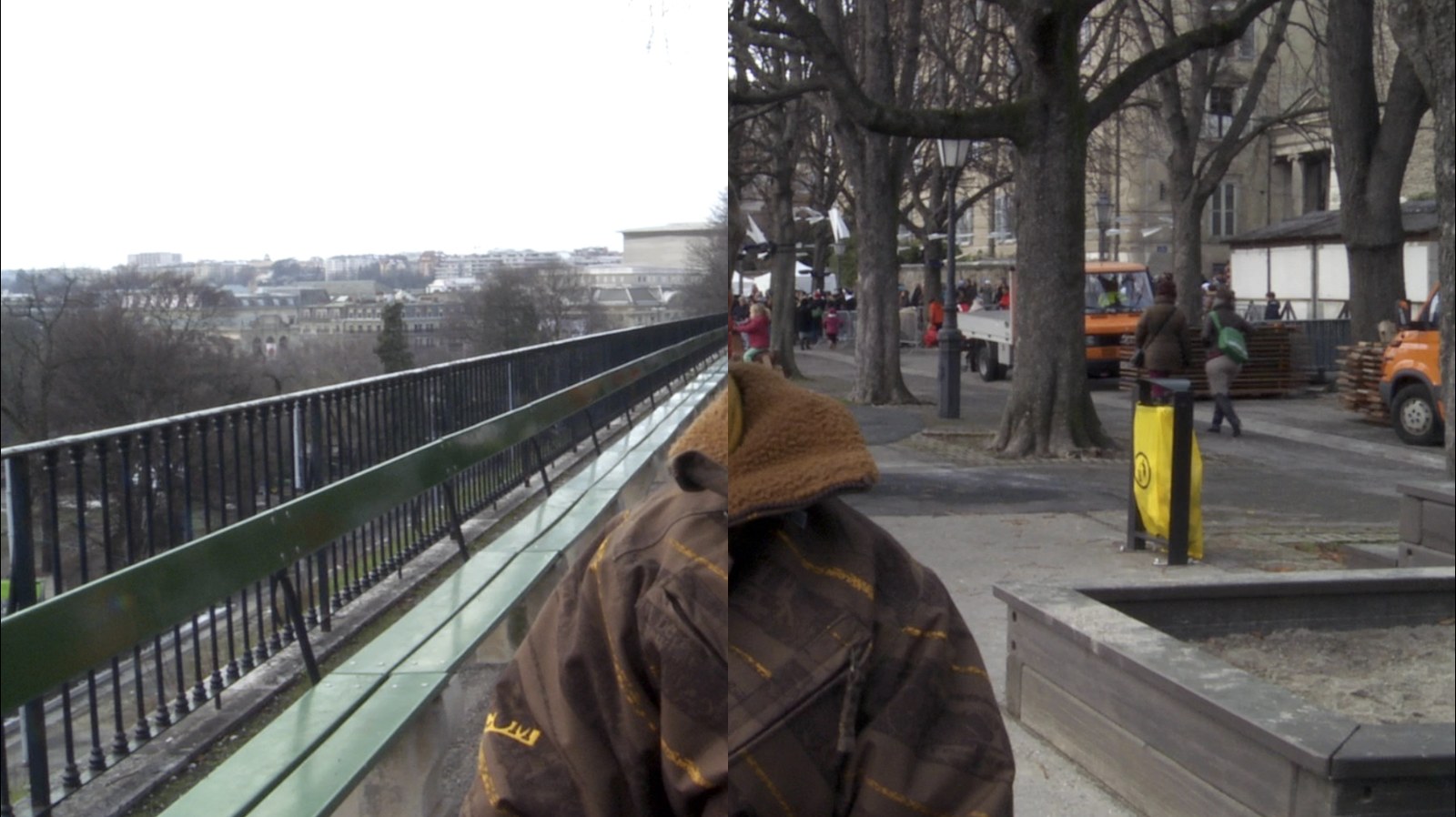 Photogramme : l'image est partagée en deux moitiés. À gauche, une balustrade de fer longeant un parc en hiver et les toits de la ville au loin ; à droite, une allée d'arbres nus où passent des silhouettes, un camion orange et une poubelle jaune. Au centre, une personne de dos, capuche de fourrure.